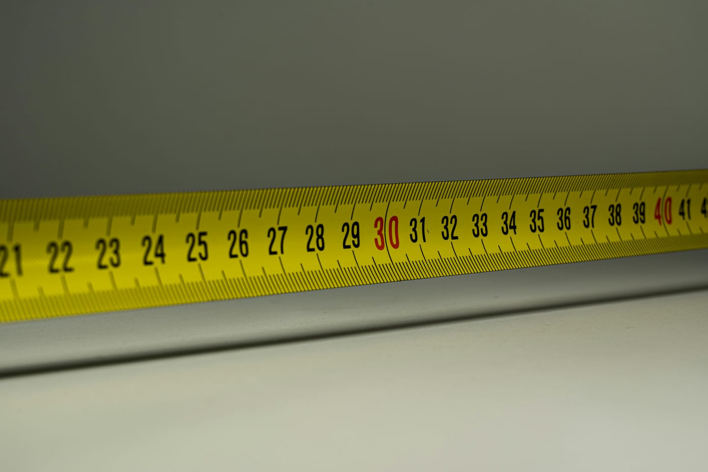 Measuring a yard with a tape for a turf quote